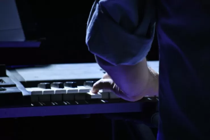 Pianist playing a grand piano at a formal event
