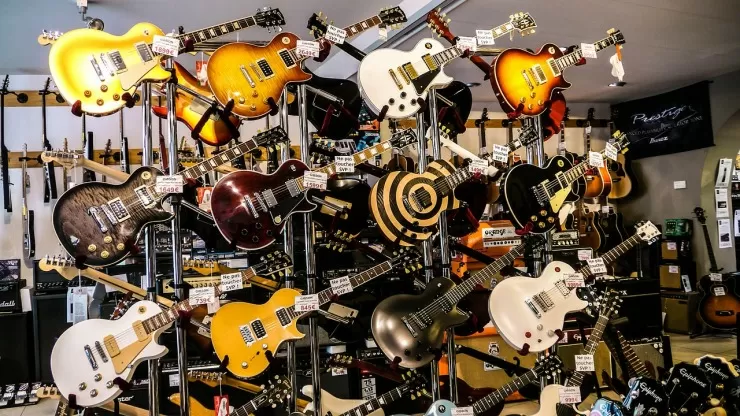 Electric guitars on display in a music shop with price tags
