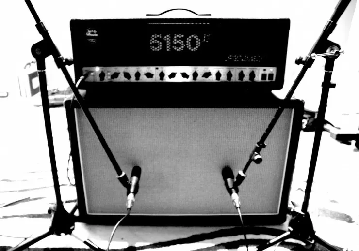 Microphone placed in front of a guitar amplifier cabinet