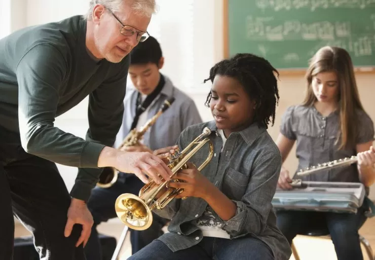 Students preparing to play musical instruments