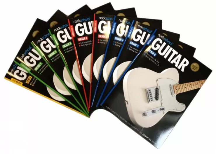 Rockschool guitar grade exam books stacked together