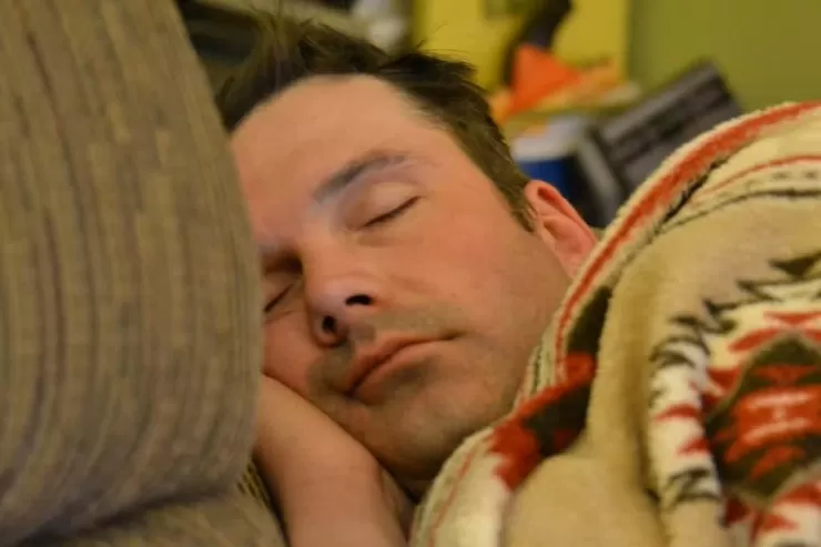 Person sleeping peacefully to rest their voice