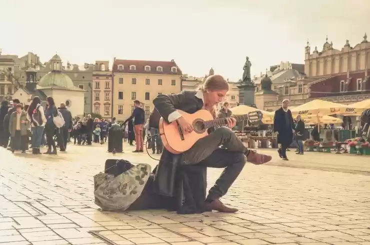 musician busking on a busy city street
