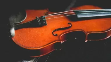 Violin resting on sheet music ready for a performance