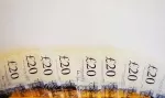 British twenty pound notes fanned out on a table