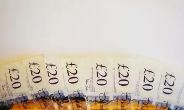 British twenty pound notes fanned out on a table
