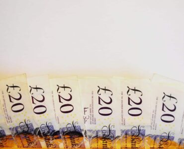 British twenty pound notes fanned out on a table