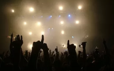 Band performing on a festival stage to a large crowd
