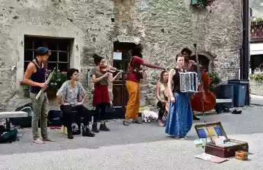 Group of street musicians busking with various instruments