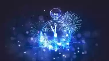Glowing clock face at midnight with blue fireworks for New Year