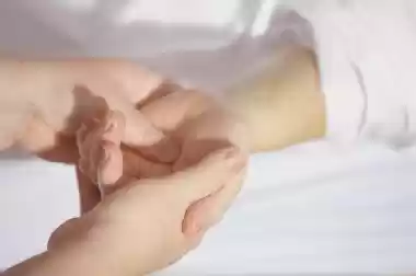 Close-up of hands massaging a wrist